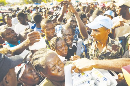 Help Wanted: Haitians crowd around to receive much needed aid after the devastating earthquake. Several Ferris organizations have set to work raising money to help aid the victims. Photo Courtesy of MCT Campus