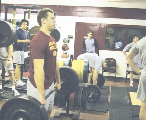 Work It Out: Blair Riley, a senior with 131 games under his belt and 76 points scored, pumps some iron with his teammates during Monday’s practice. Photo By: Kristyn Sonnenberg | Photo Editor