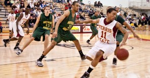 Making a Run for It: Junior Darien Gay (#11) flies past Northern Michigan opponents during a recent game. Gay scored 10 points during Saturday’s game against Northern, contributing to a 90-76 victory. Photo By: Kristyn Sonnenberg | Photo Editor